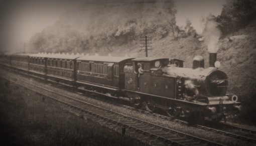 No.1060on a Liverpool Street to Chelmsford fast train leaving Brentwood in May 1908.  The first three carriages are fresh out of the carriage repair shops having lost their varnished teak finish and are now painted in the golden brown livery with yellow lining around the windowns and upper beading. Photograph ©Public Domain.