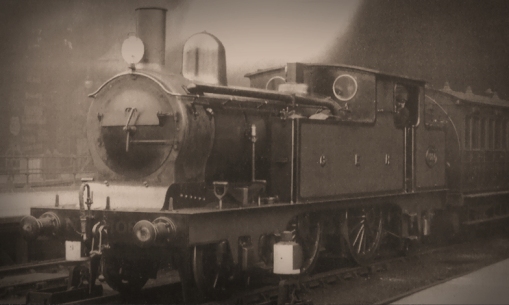 Number 1084 in the Stygian gloom at Liverpool Street prior to November 1904 when it entered Works for rebuilding with a 160psi boiler in 1904. The paintwork on the tank sides and boiler has been well looked after by the crew, but much of the paint on the smokebox and its door has been completely burnt off under heavy load. The loco displays the simple headcode for an ordinary passenger train. Photograph ©Public Domain