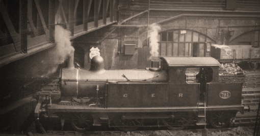 No. 791 was rebuilt in February 1898 and is seen here in the Platform 6 engine dock at Liverpool Street in the Edwardian period after 1903, probably before its second rebuild with a 2-ring telescopic boiler in 1910.  Fewer outward changes than the first thirty locos, but it has received 10 spoke radial wheels and exhibits all the features future builds would be given from new. Photograph  © Public Domain.